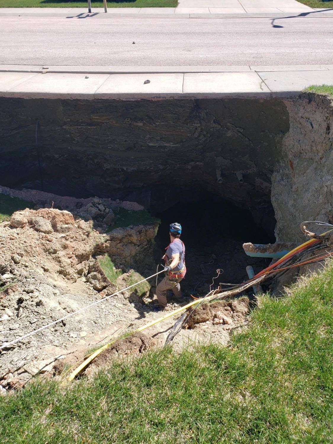 Caver Adam Weaver lowers himself into the mine